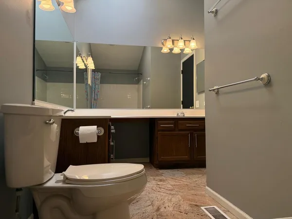a bathroom with a toilet a sink and shower