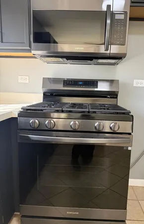 a stove top oven sitting inside of a kitchen