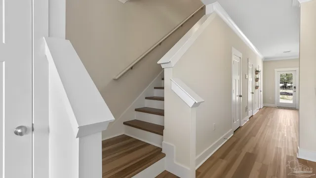 a view of a hallway with wooden floor and entryway