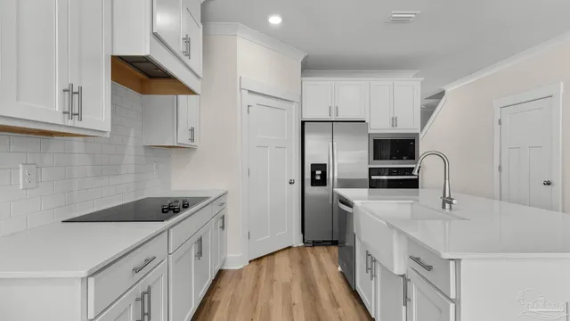 a kitchen with stainless steel appliances a sink stove and refrigerator