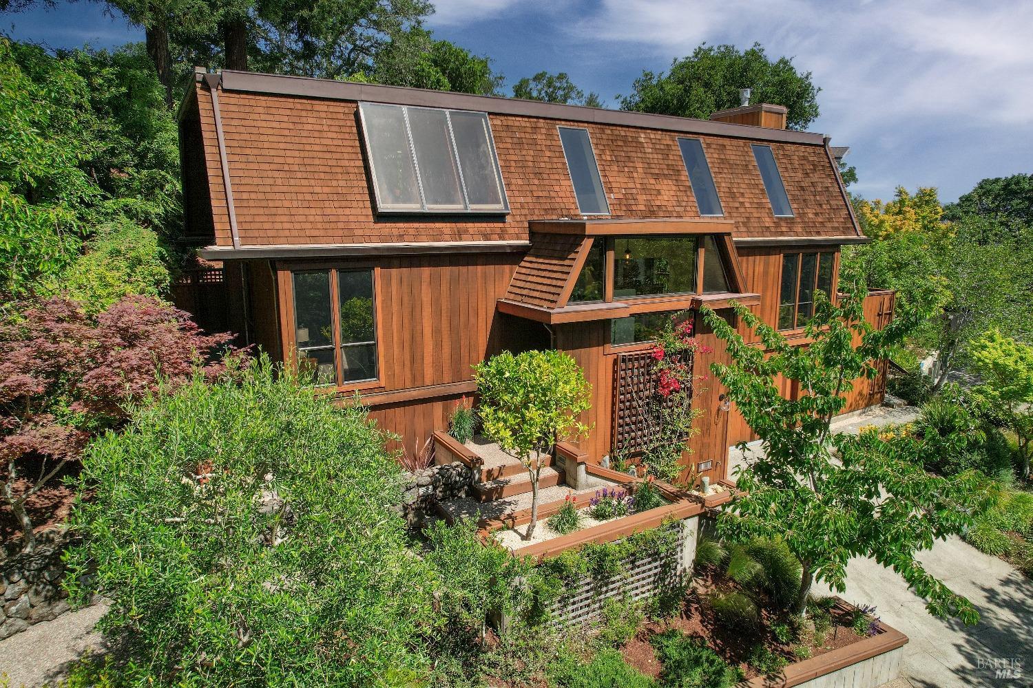 an aerial view of a house with balcony and garden