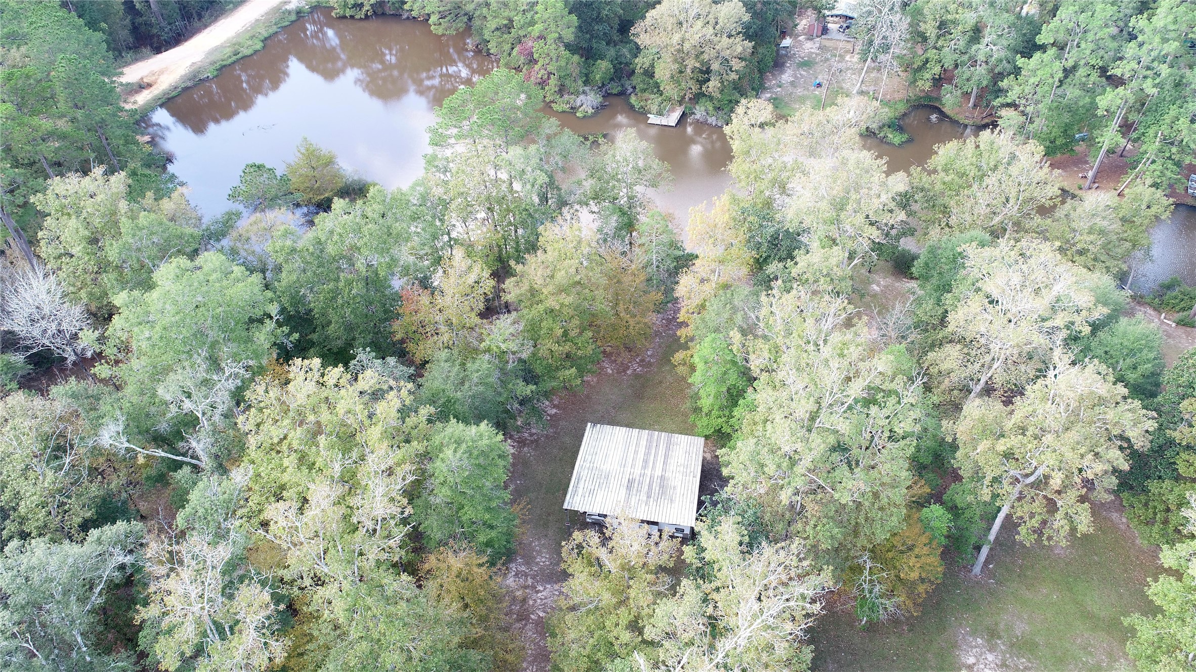 630 Hillbilly Heaven Road Livingston, TX 77351 - Photo 15 of 17 an aerial view of a house with a yard and lake view