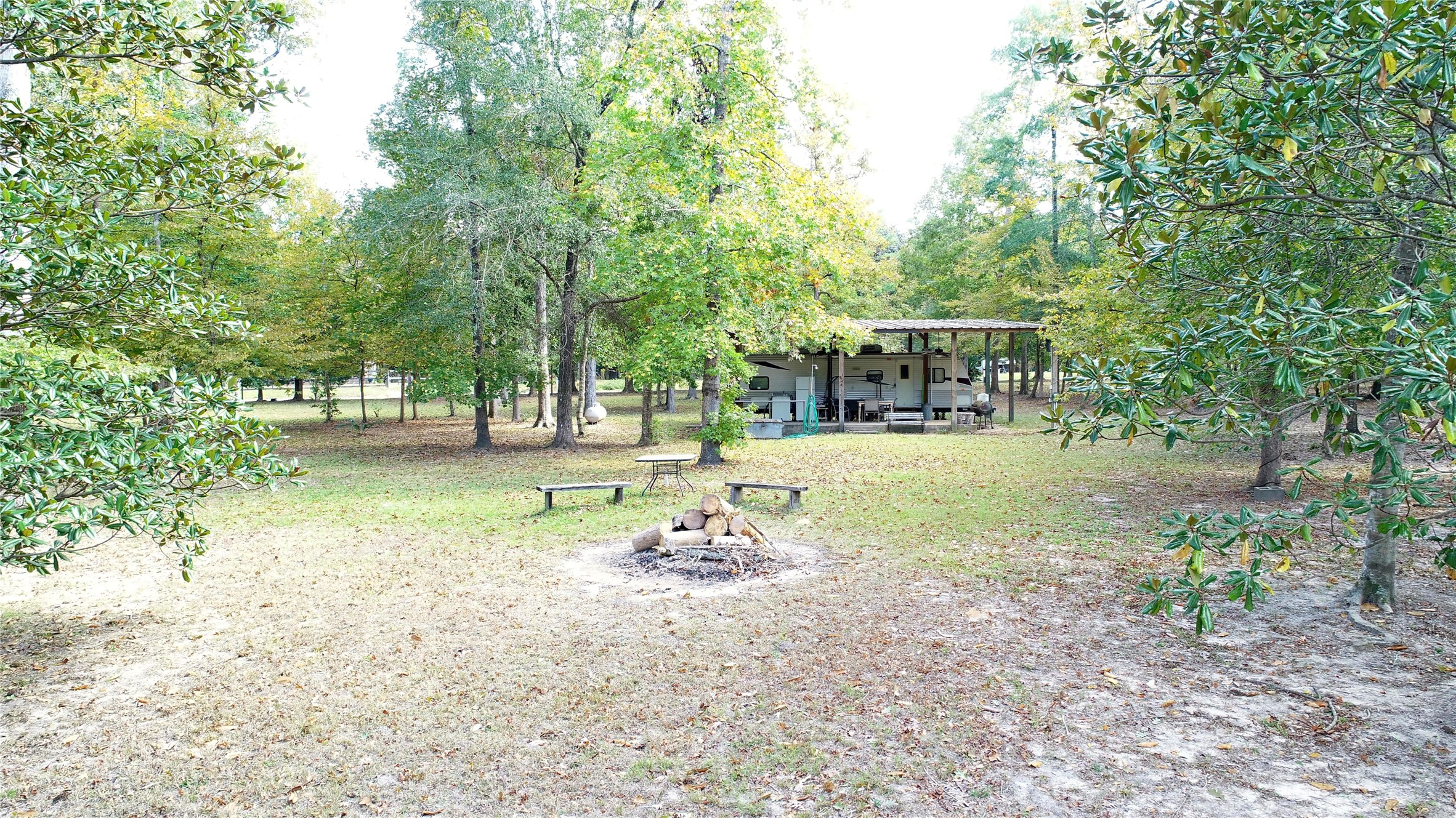 630 Hillbilly Heaven Road Livingston, TX 77351 - Photo 2 of 17 a backyard of a house with a yard and outdoor seating