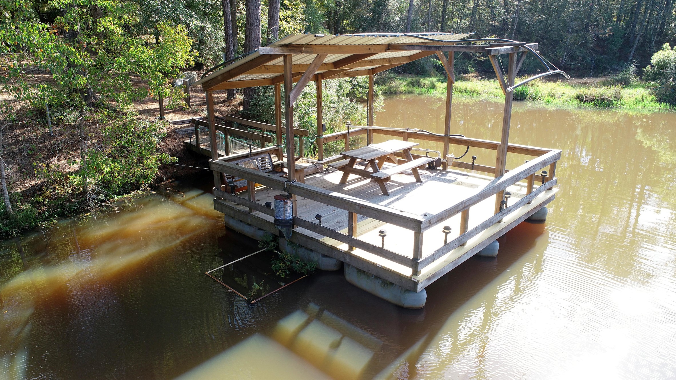 630 Hillbilly Heaven Road Livingston, TX 77351 - Photo 5 of 17 a view of a wooden deck with furniture