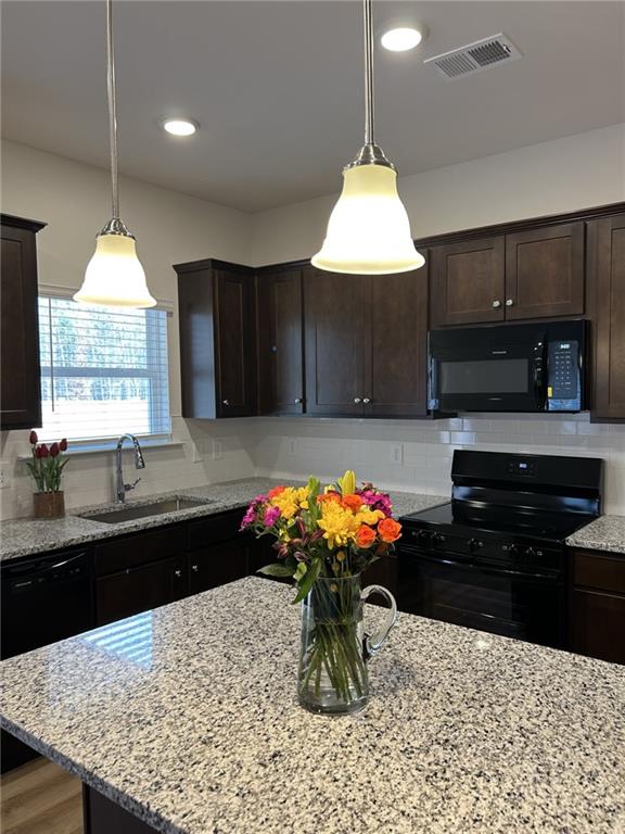 23 Whistling Oaks NE Drive Rome, GA 30165 - Photo 5 of 26 a kitchen with stainless steel appliances granite countertop a sink a stove and a wooden floors