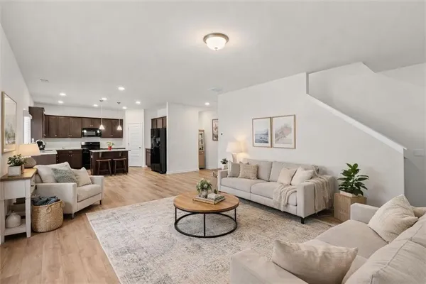 a living room with furniture kitchen view and a couch