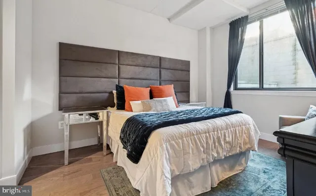 a bedroom with a bed and a window