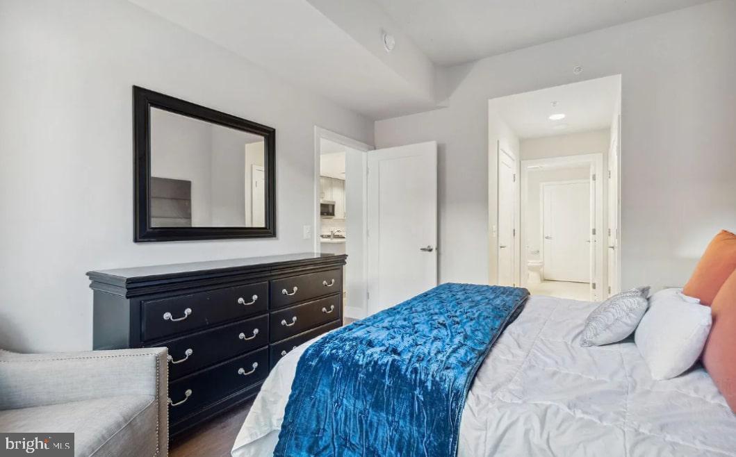 50 Florida Avenue Northeast, Unit 112 Washington, DC 20002 - Photo 6 of 15 a bedroom with a bed and a mirror on dresser