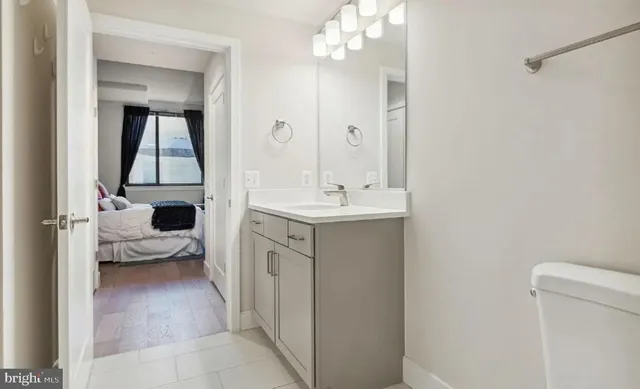 a en suite bathroom with a sink a mirror and a shower