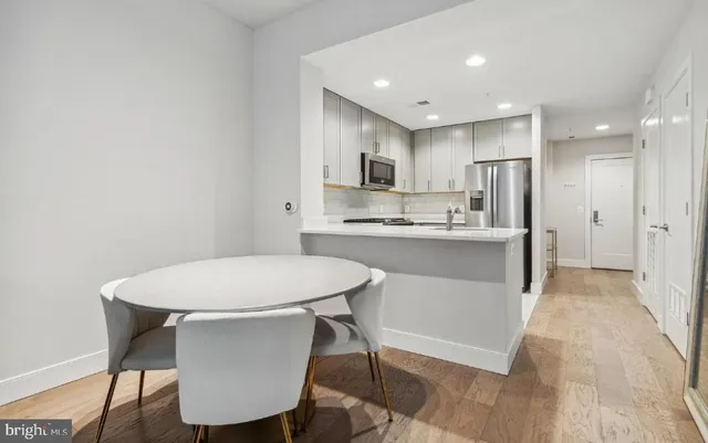 a kitchen with kitchen island a sink counter and chairs