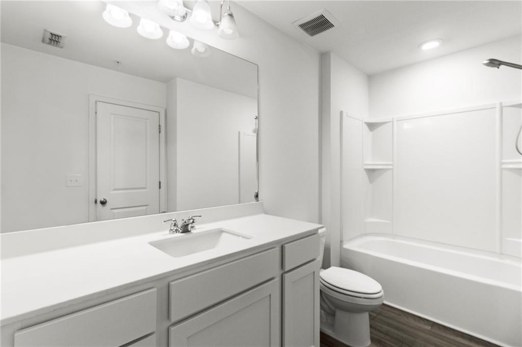 509 Magnolia Circle Palmetto, GA 30268 - Photo 12 of 24 a bathroom with a sink a toilet and shower