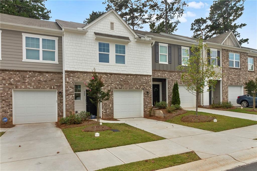 509 Magnolia Circle Palmetto, GA 30268 - Photo 2 of 24 a front view of a house with a yard and garage
