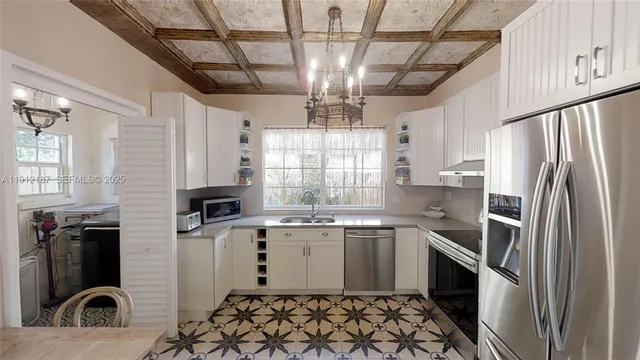 a kitchen with granite countertop a sink stainless steel appliances and cabinets