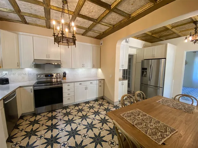 a kitchen with stainless steel appliances a refrigerator sink and cabinets