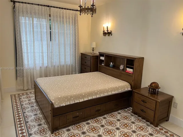 a bed sitting in a bedroom with a rug