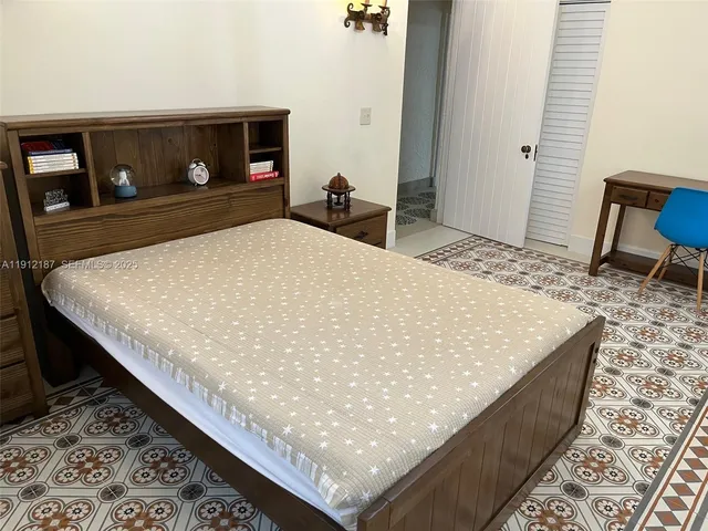 a bathroom with a granite countertop toilet sink and mirror