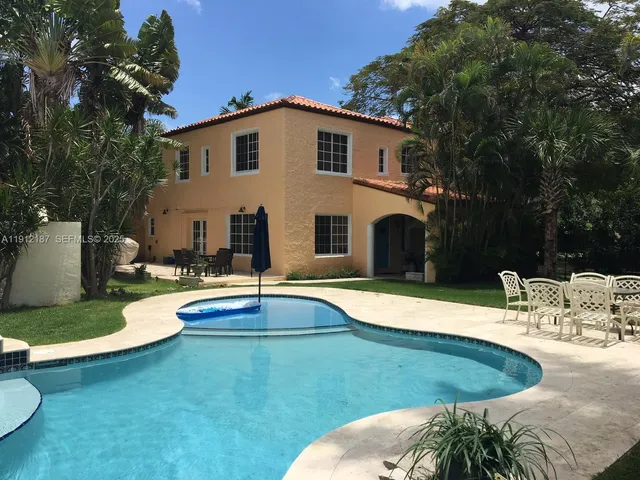 a view of a swimming pool with an outdoor space and seating area