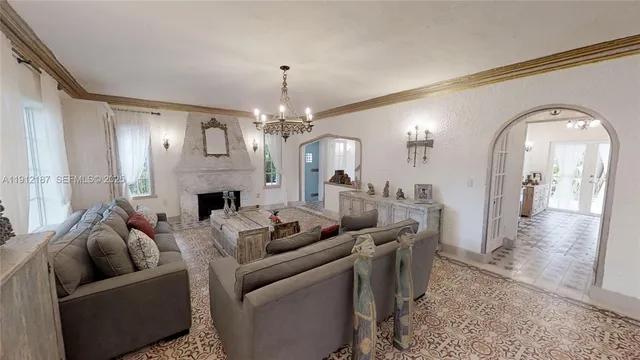a living room with furniture and a chandelier