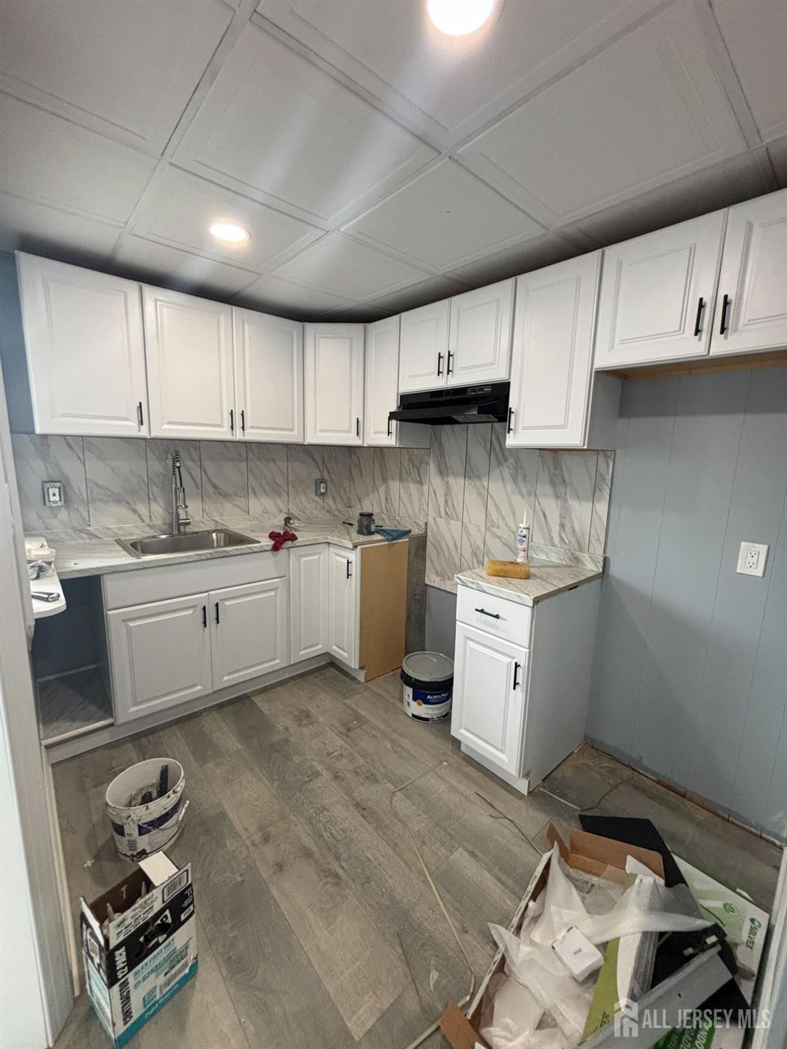a kitchen with a sink window and cabinets