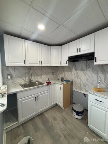 a kitchen with a sink and cabinets