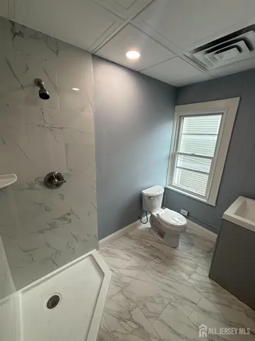 a bathroom with a bathtub and shower