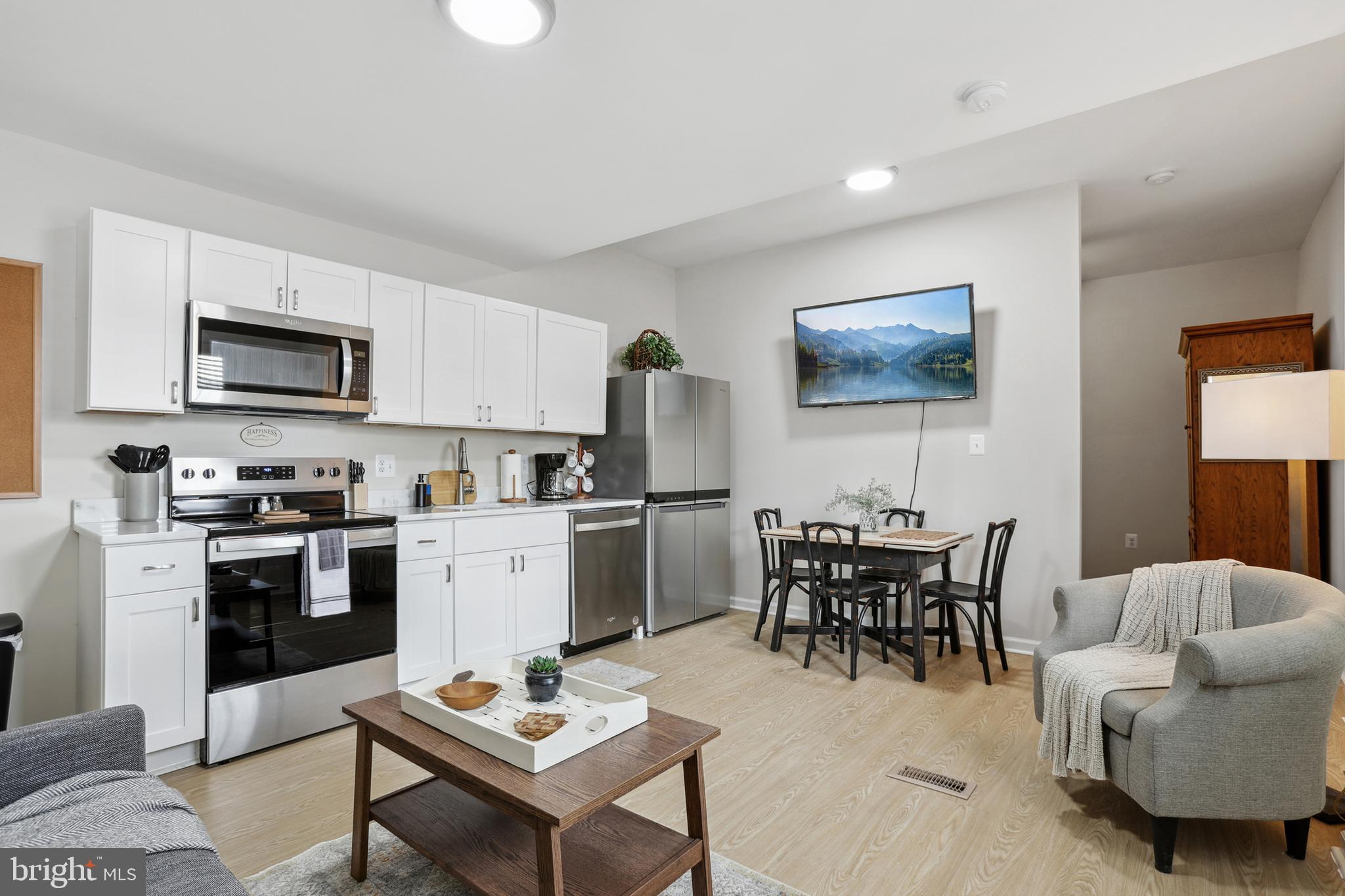 1900 Princess Anne Street, Unit 5 Fredericksburg, VA 22401 - Photo 3 of 19 a kitchen with a dining table and appliances