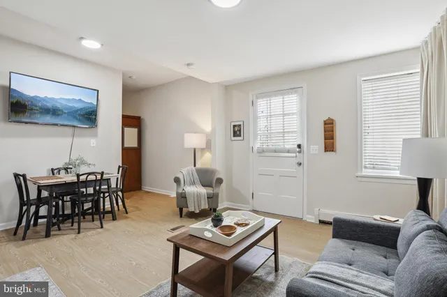 a living room with furniture and wooden floor