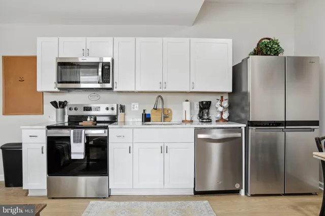 a kitchen with a refrigerator stove and microwave