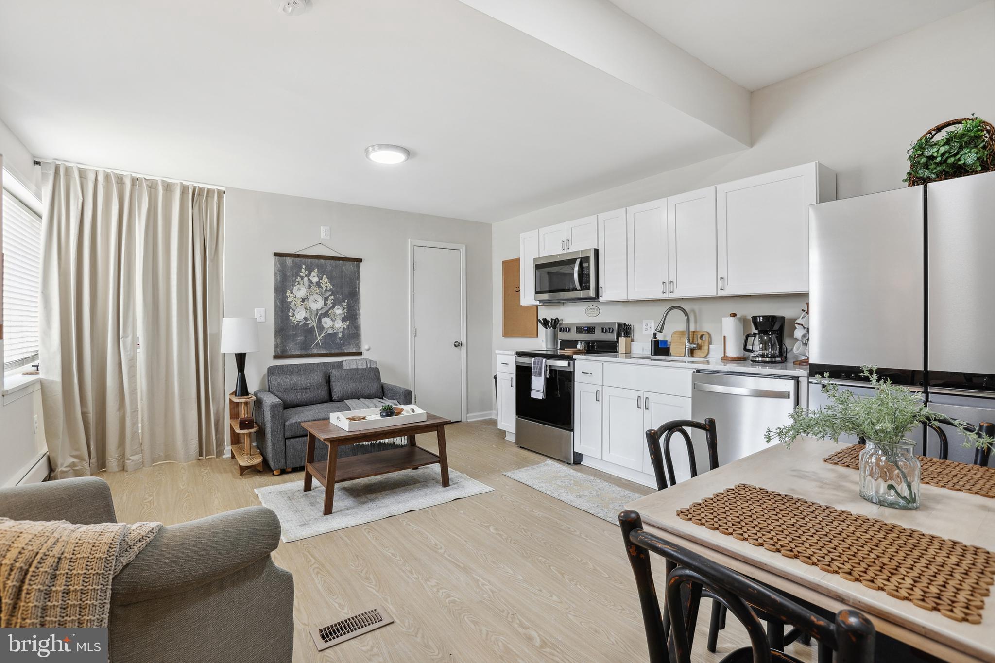 1900 Princess Anne Street, Unit 5 Fredericksburg, VA 22401 - Photo 7 of 19 a kitchen with sink refrigerator dining table and chairs