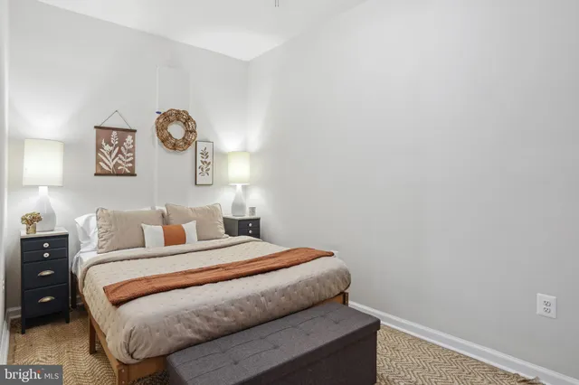 a bedroom with a bed and painting on the wall