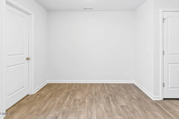a view of a room with wooden floor