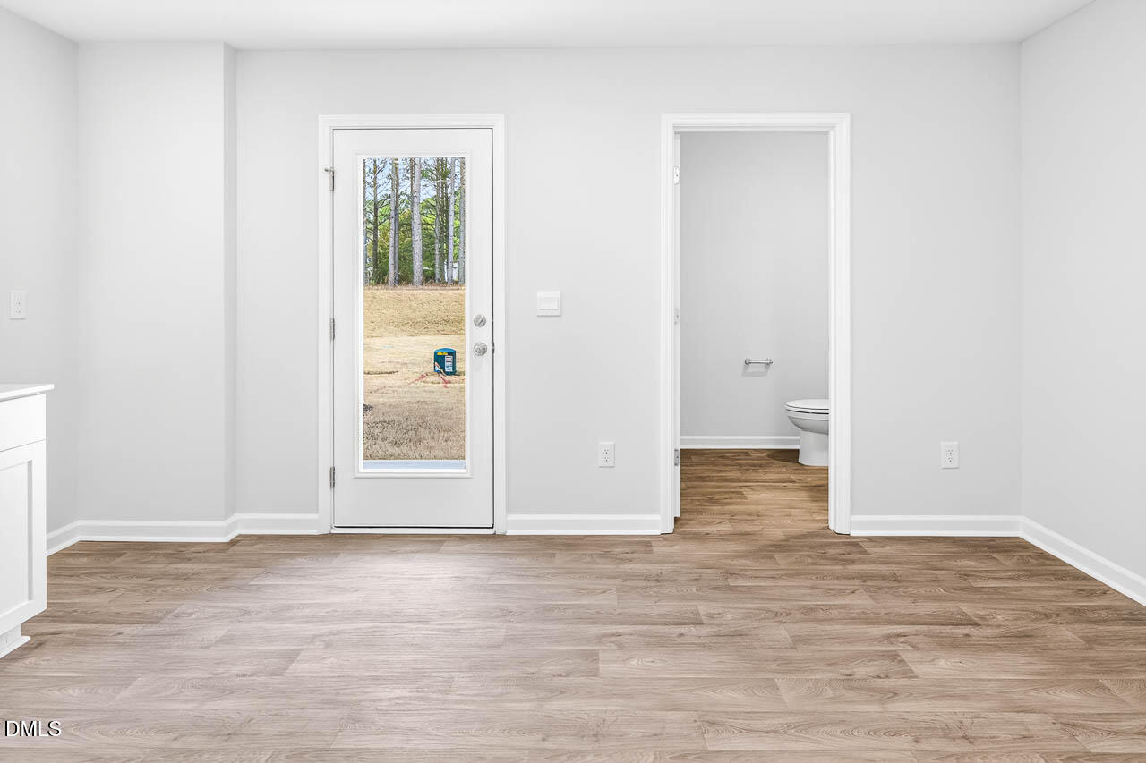 8535 Beckett Chase Way Raleigh, NC 27616 - Photo 14 of 33 an empty room with wooden floor and windows