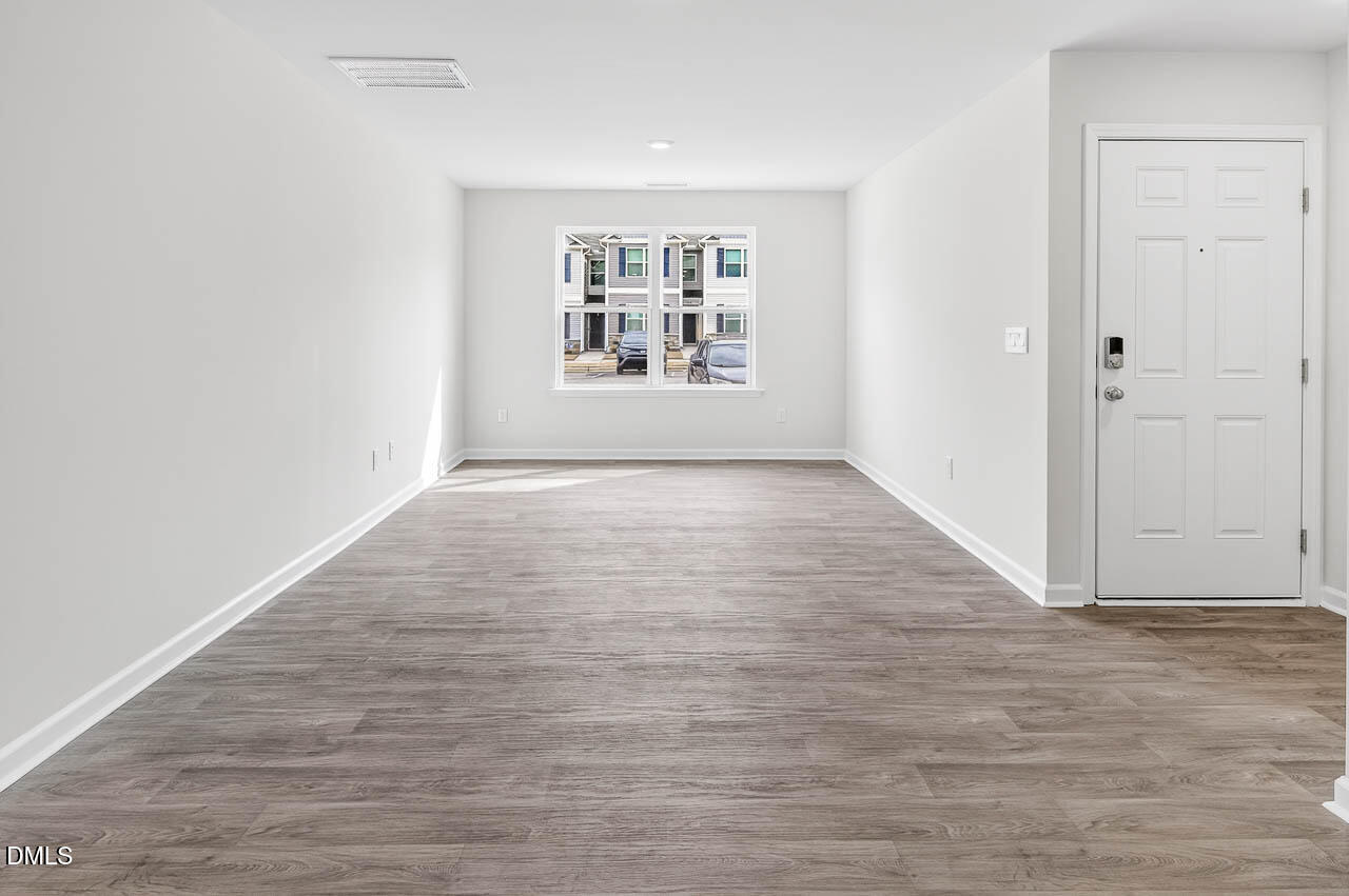 8535 Beckett Chase Way Raleigh, NC 27616 - Photo 16 of 33 wooden floor in an empty room with a window