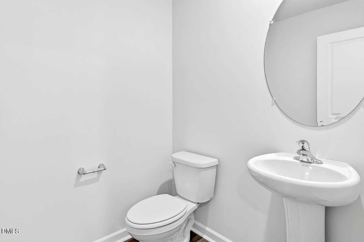 8535 Beckett Chase Way Raleigh, NC 27616 - Photo 17 of 33 a bathroom with a sink a toilet and a mirror