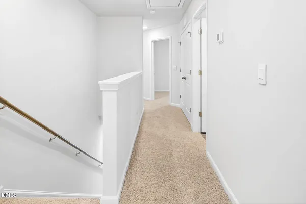 a view of a hallway with white walls