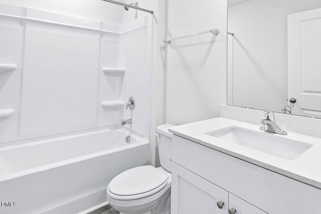 8535 Beckett Chase Way Raleigh, NC 27616 - Photo 27 of 33 a bathroom with a sink a toilet and a bathtub