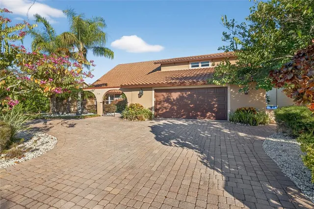 a front view of a house with a yard and a garage