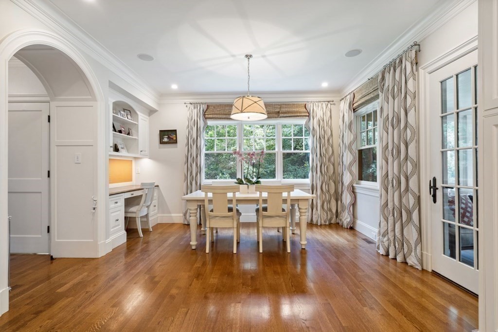 45 Ravine Road Wellesley, MA 02481 - Photo 19 of 42 a dining room with wooden floor a chandelier a glass table and chairs