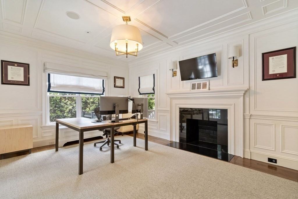 45 Ravine Road Wellesley, MA 02481 - Photo 20 of 42 a view of a livingroom with a fireplace a chandelier and windows