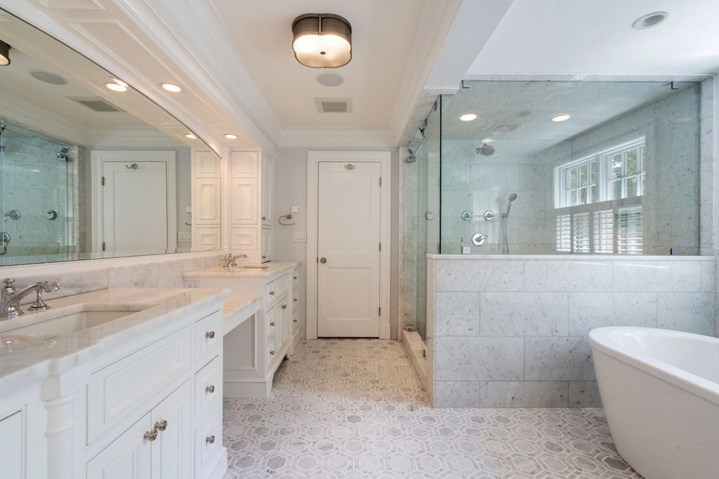 45 Ravine Road Wellesley, MA 02481 - Photo 22 of 42 a spacious bathroom with a granite countertop sink a toilet a shower and a mirror