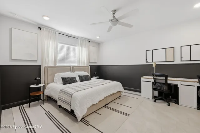 a bedroom with a bed and a television