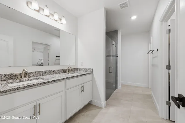 a bathroom with a shower and a glass door