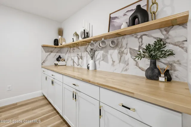 a view of a room with wooden floor and furniture