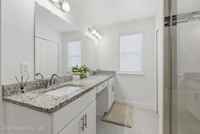 a view of walk in closet with clothes