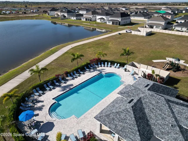an aerial view of a house with a swimming pool yard and outdoor seating