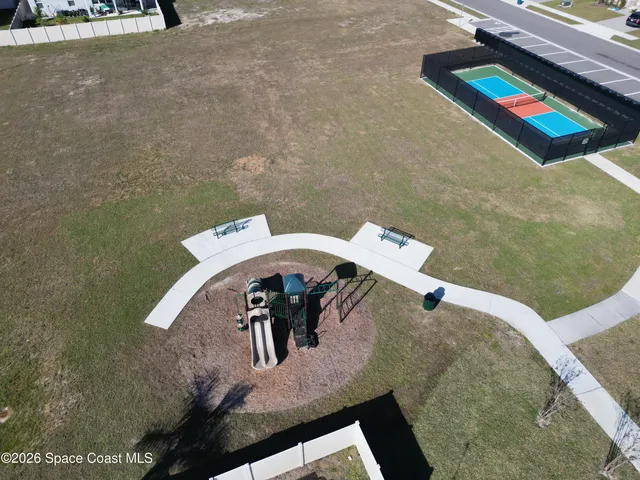 an aerial view of a houses with ocean view