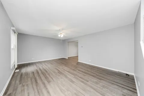 a view of an empty room and wooden floor