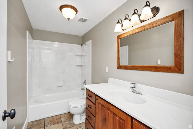 2912 South 1080th Street West Logan, UT 84321 - Photo 23 of 43 Bathroom featuring a single vanity with wood cabinetry, a white countertop, and an integrated sink