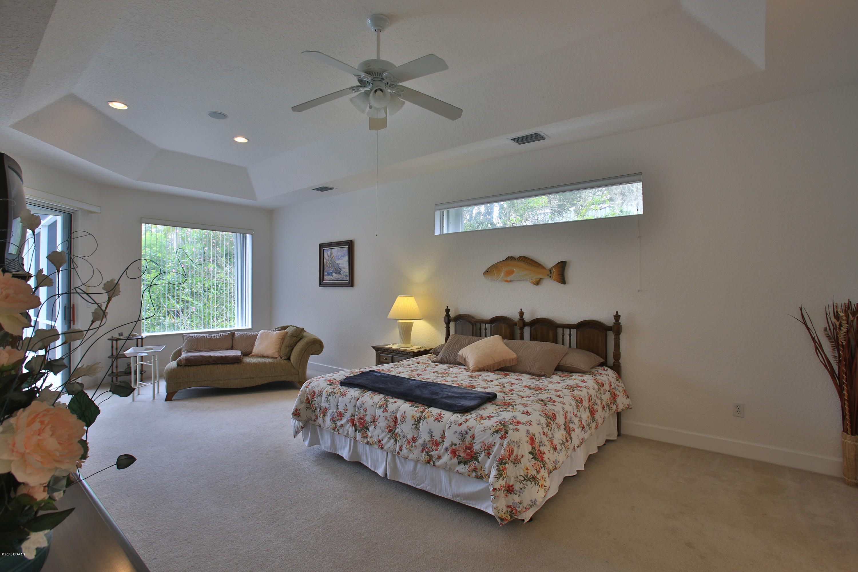 35 Inlet Point Boulevard Ponce Inlet, FL 32127 - Photo 12 of 34 a bedroom with a bed couch and a window