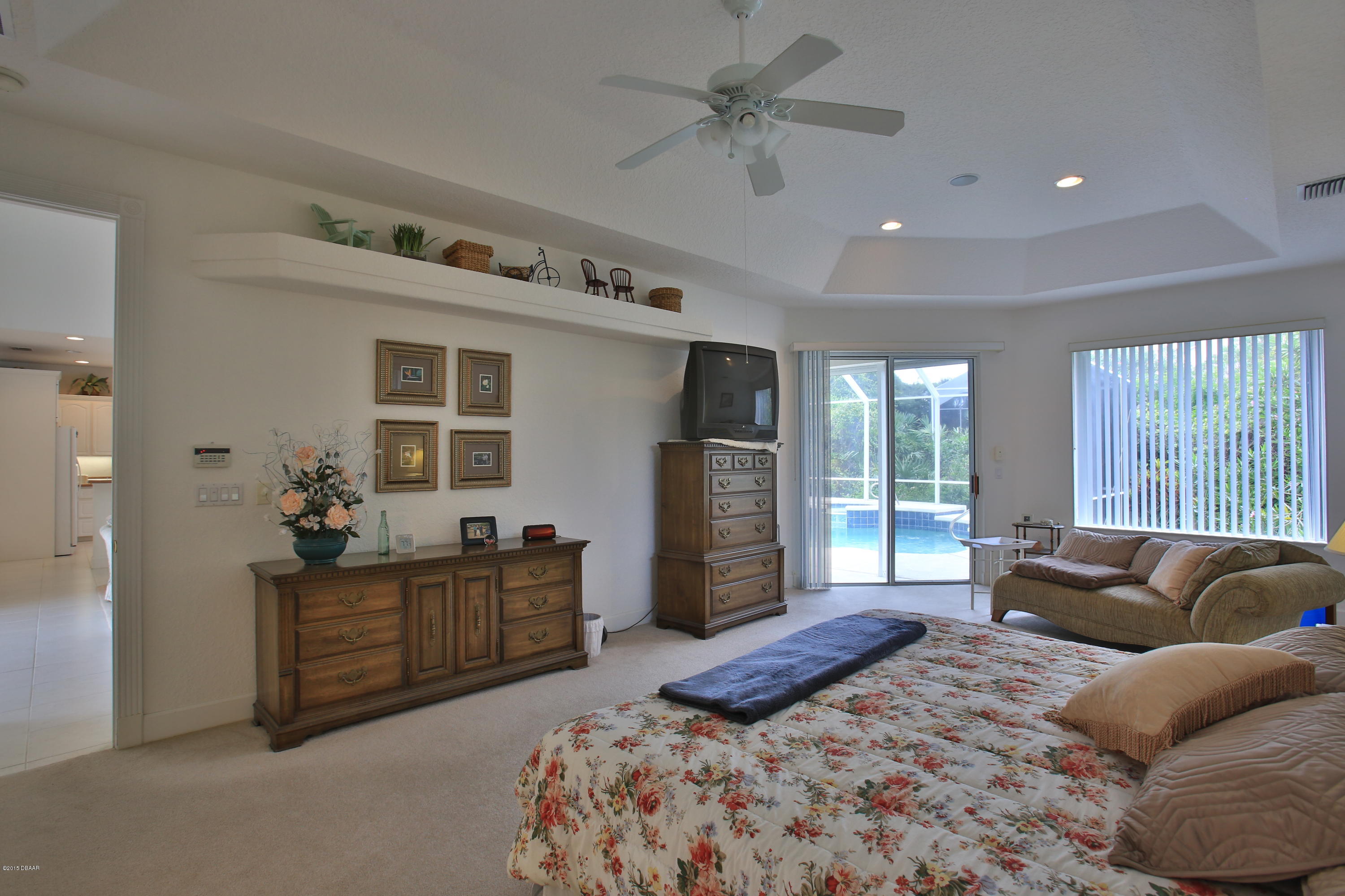 35 Inlet Point Boulevard Ponce Inlet, FL 32127 - Photo 13 of 34 a bedroom with a bed dresser and a large window